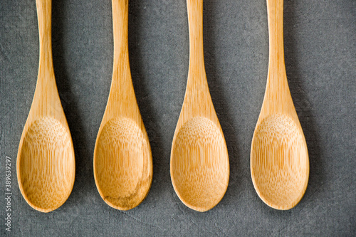 Empty wooden spoon on the gray background