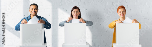 Εκτύπωση καμβά multicultural electors inserting ballots into polling booths, banner
