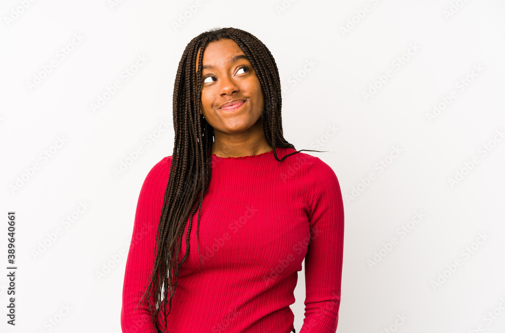 Young african american woman isolated dreaming of achieving goals and purposes Young african american woman isolated dreaming of achieving goals and purposes