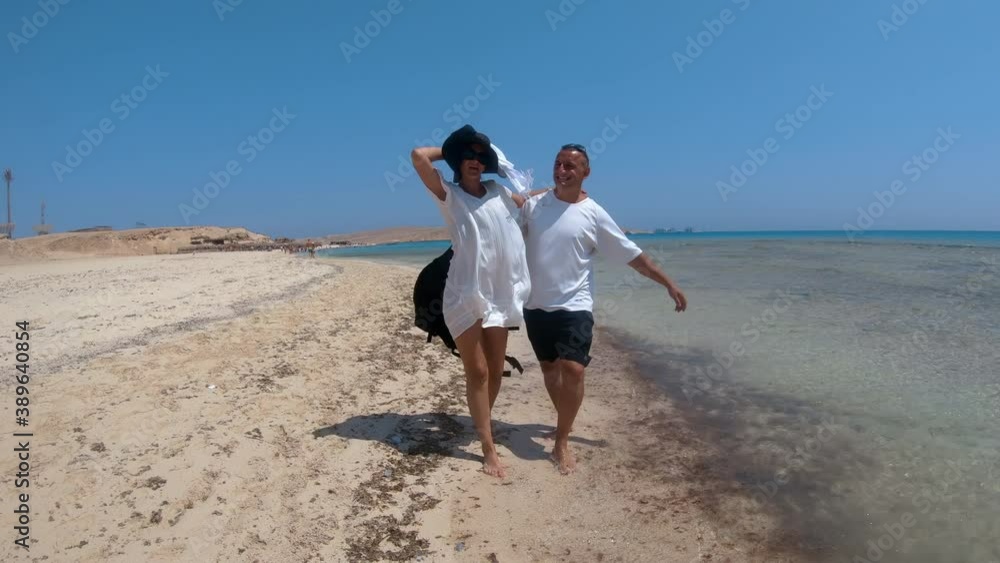 Romantic Couple on walking on shallow tropical Giftun island, Paradise beach, Hurghada, Egypt Romantic Couple on walking on shallow tropical Giftun island, Paradise beach, Hurghada, Egypt