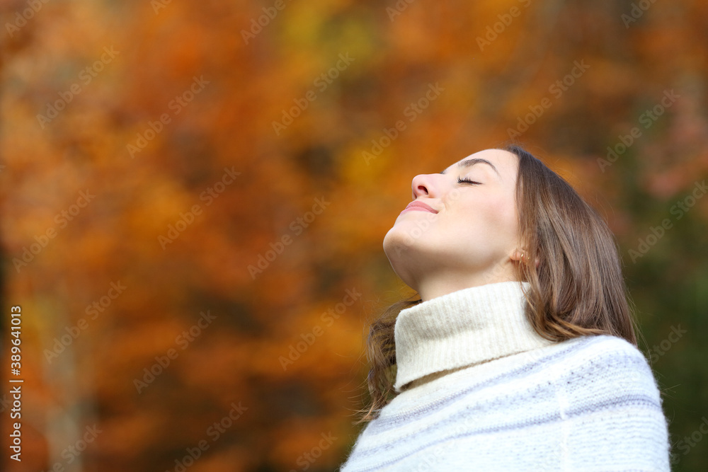 Relaxed woman breathing fresh air in autumn in a park Relaxed woman breathing fresh air in autumn in a park