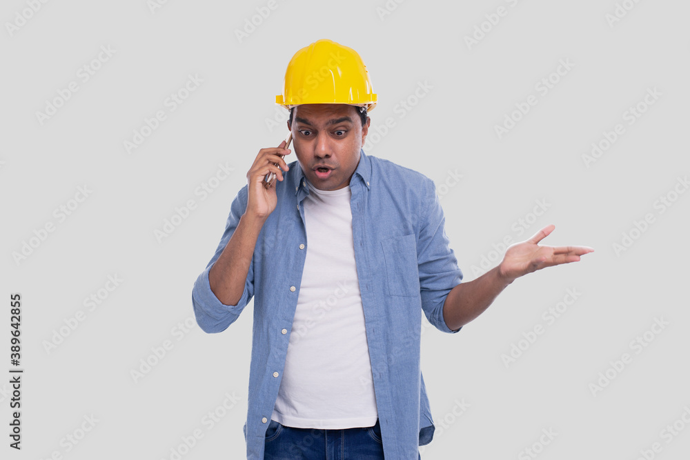 Construction Worker Talking on the Phone Angry. Architect Holding Phone. Yellow Hard Helmet. Man Isolated Talking on Phone Confused. Man Having a Call at Work