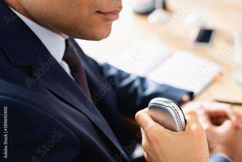 Canvas Print cropped view of journalist with dictaphone interviewing indian politician during