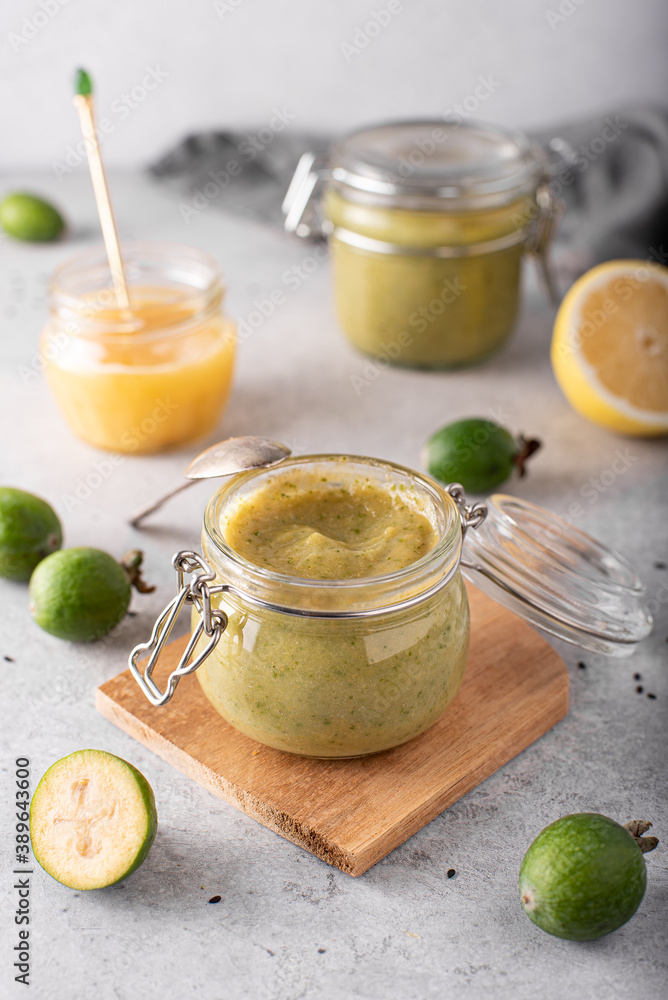 feijoa mashed with lemon and honey in glass jars on a light background feijoa mashed with lemon and honey in glass jars on a light background