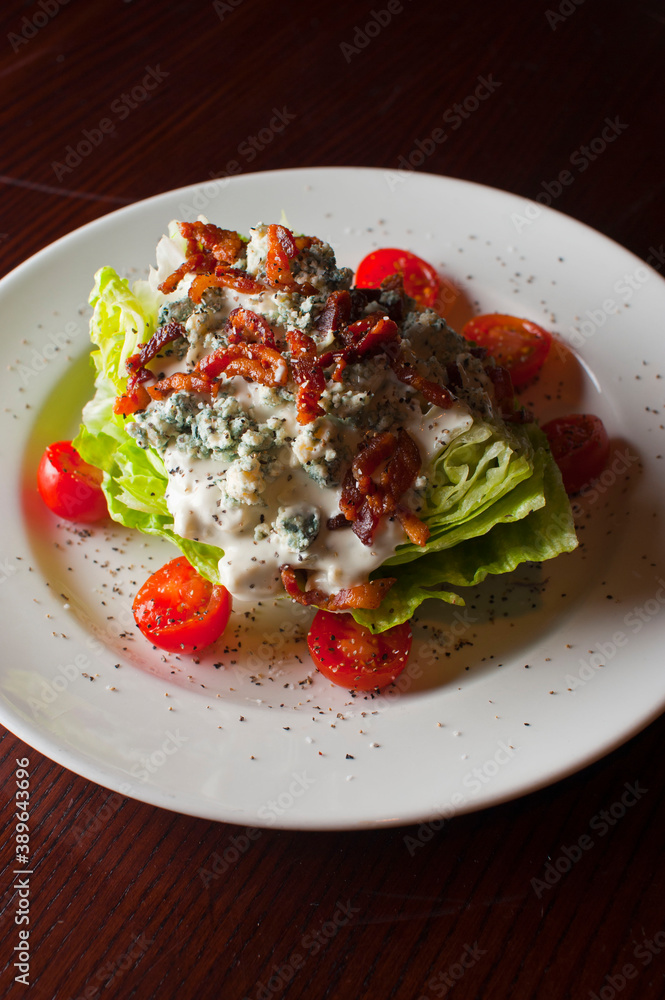 Wedge Salad. Iceberg Lettuce, blue cheese dress and shredded carrots. Classic American steakhouse or restaurant favorite. Wedge Salad. Iceberg Lettuce, blue cheese dress and shredded carrots. Classic American steakhouse or restaurant favorite.