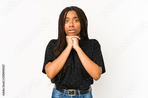 Young african american woman isolated on white background praying for luck, amazed and opening mouth looking to front.