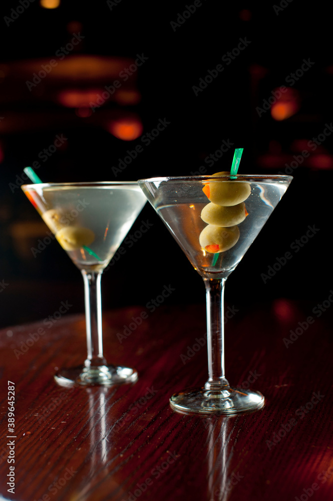 Cocktails. Traditional American drinks made by bartenders or mixologists in speakeasy or upscale bars and taverns. Cocktails served in chilled cocktail glasses and garnished with fruit.