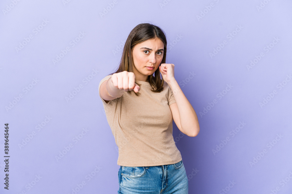 Young caucasian woman throwing a punch, anger, fighting due to an argument, boxing. Young caucasian woman throwing a punch, anger, fighting due to an argument, boxing.