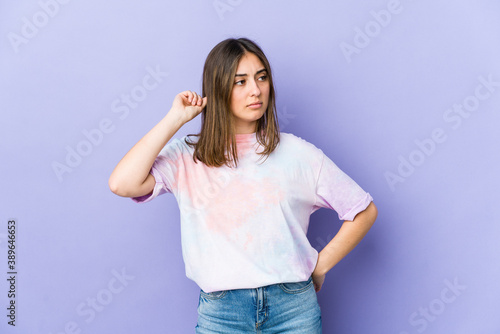 Young caucasian woman covering ears with fingers, stressed and desperate by a loudly ambient.