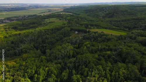 Aerial drone flight over green hill and cottage, opening beautiful panorama view. Hungary, Europe 4K photo