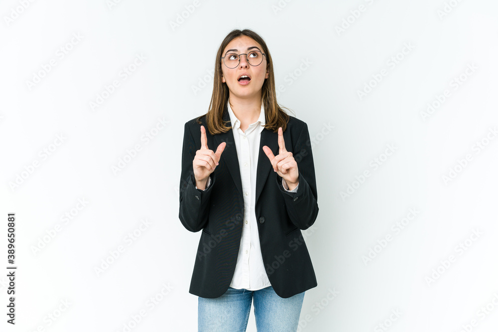 Young caucasian business woman pointing upside with opened mouth. Young caucasian business woman pointing upside with opened mouth.