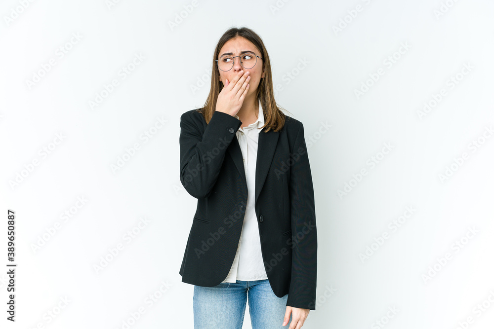 Young caucasian business woman yawning showing a tired gesture covering mouth with hand. Young caucasian business woman yawning showing a tired gesture covering mouth with hand.