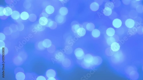 Blue defocused lights . Abstract blue blurred bokeh background from Christmas lights. The Flashing Lights Of The Christmas Tree Twinkle. The Concept Of The Winter Holidays.