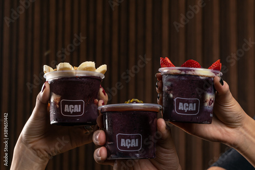 Mix of Delicious Brazilian Açaí Cream, in a plastic Cup With a variety of Toppings. Summer acai smoothie