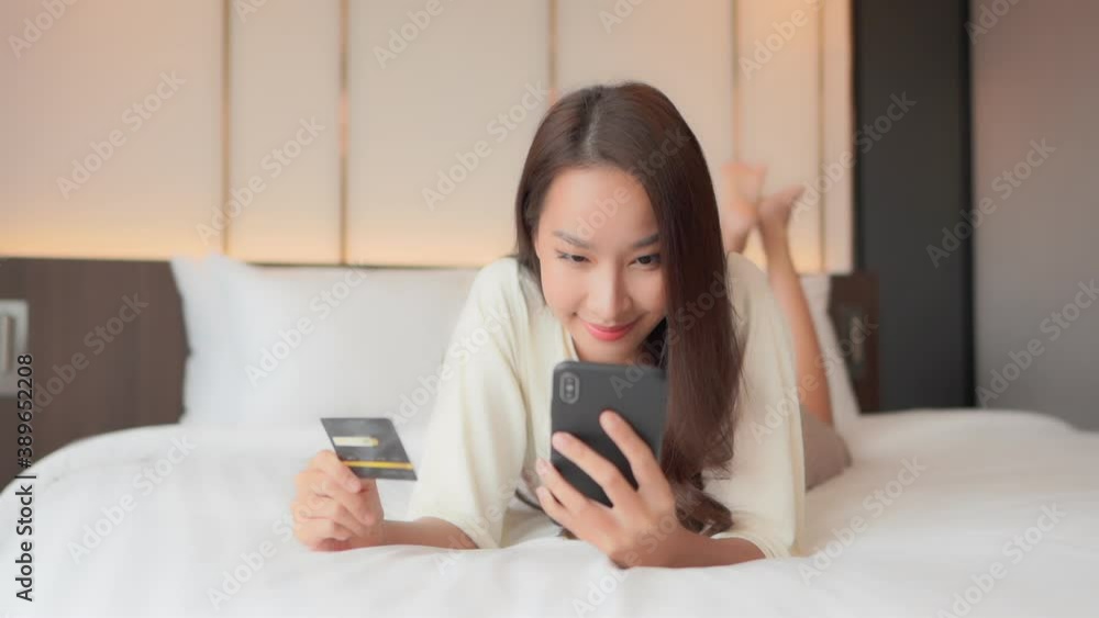 Rich asian woman mindlessly shopping online Rich asian woman mindlessly shopping online