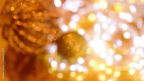 Golden Christmas bokeh from light and twinkling garlands blurred focus . background video of the winter holiday