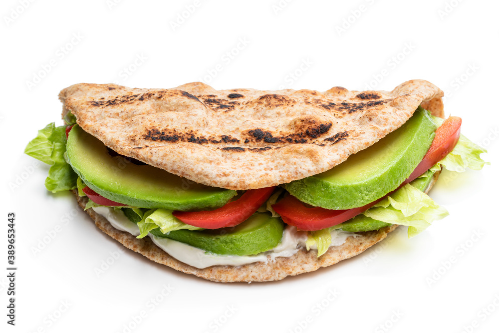 Folded wholemeal flatbread with vegetables isolated on white Folded wholemeal flatbread with vegetables isolated on white