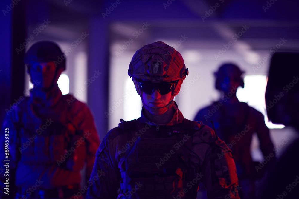 soldier squad team walking in urban environment colored lightis