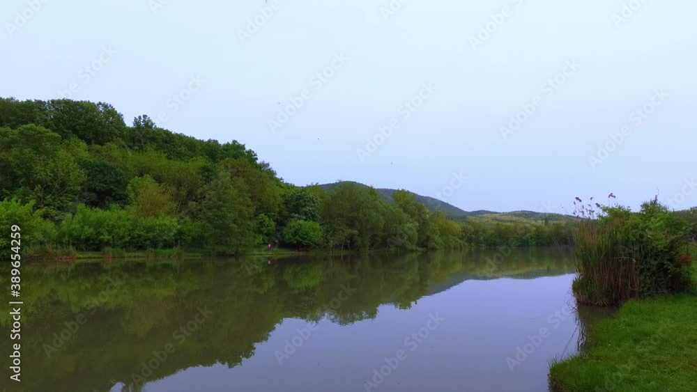 Walking along at lake shore. Nature at sunset. Hand held. Hungary, Europe. 4K