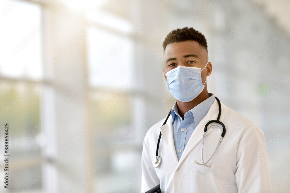 Portrait of young doctor with face mask at the hospital