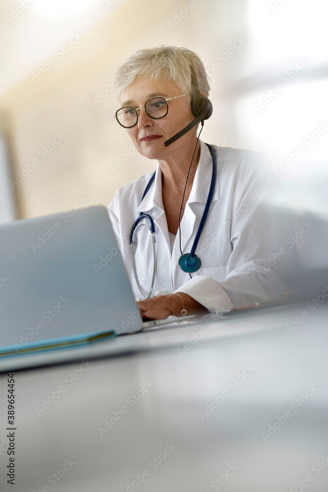 Practitioner in office having virtual consultation online with patient Practitioner in office having virtual consultation online with patient