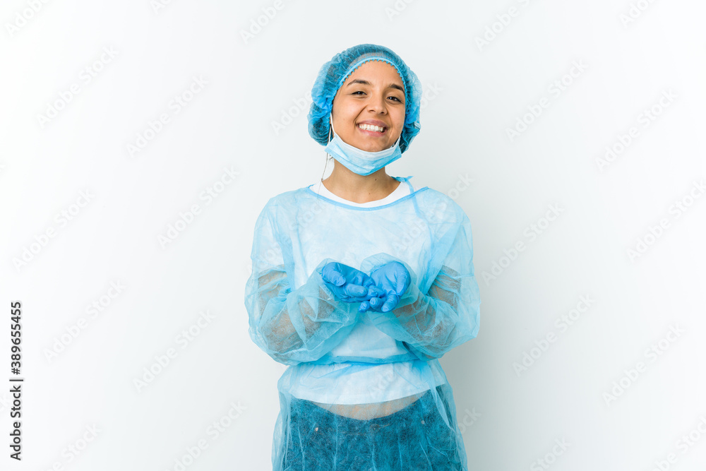 Young surgeon latin woman isolated on white background holding something with palms, offering to camera. Young surgeon latin woman isolated on white background holding something with palms, offering to camera.
