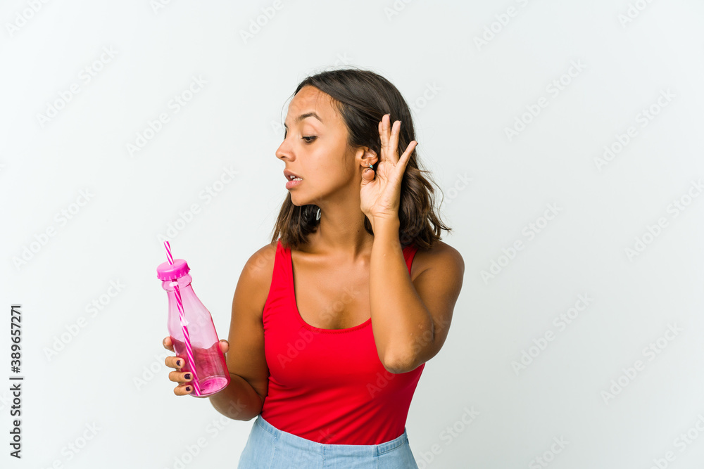 Young latin woman holding a milkshake isolated on white background Young latin woman holding a milkshake isolated on white background
