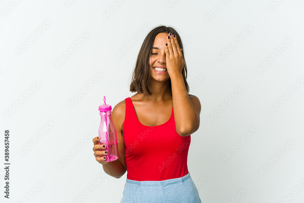 Young latin woman holding a milkshake isolated on white background Young latin woman holding a milkshake isolated on white background