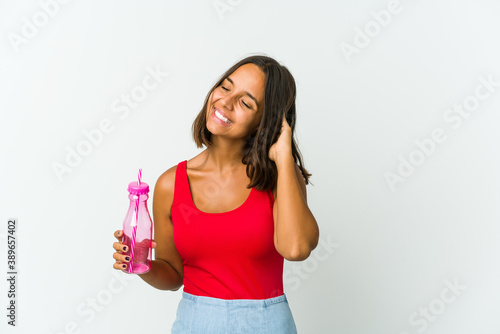 Young latin woman holding a milkshake isolated on white background