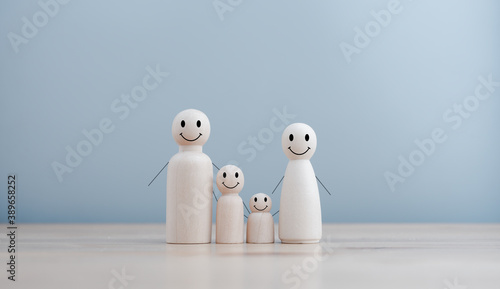 wooden doll family happy face, family home, adoption foster care, homeless support , family mental health, domestic violence, social distancing photo