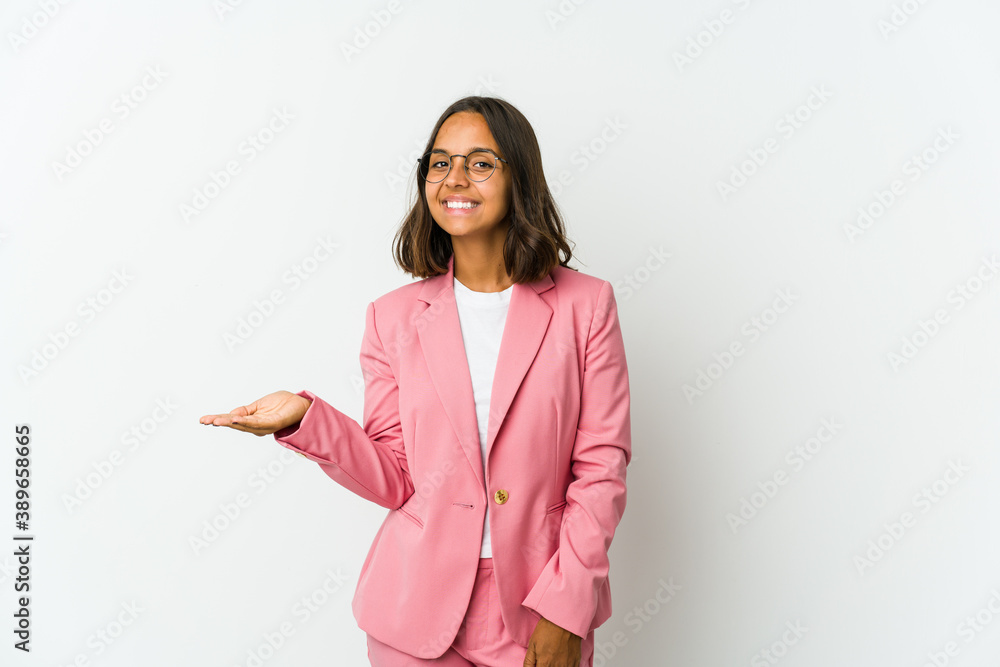 Young latin business woman isolated on white background pointing with finger at you as if inviting come closer. Young latin business woman isolated on white background pointing with finger at you as if inviting come closer.