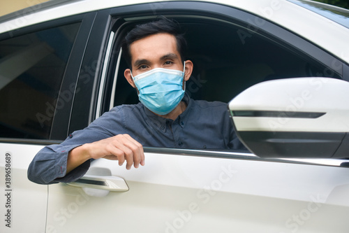Asian man wear face mask sitting in car protect coronavirus covid 19