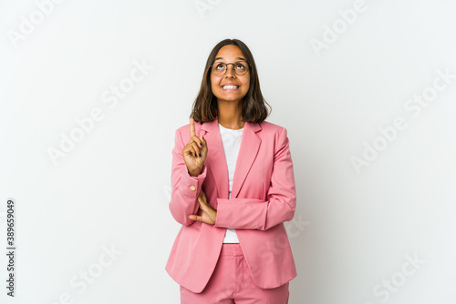 Young latin business woman isolated on white background being shocked due to an imminent danger