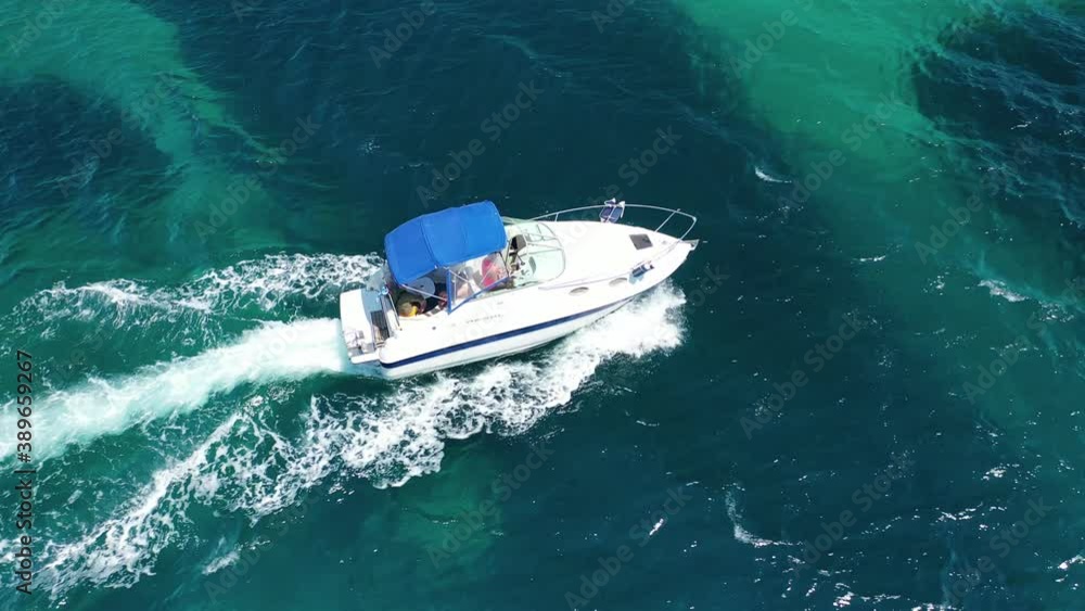 Aerial drone tracking video of speed boat cruising in high speed in deep blue Aegean sea Aerial drone tracking video of speed boat cruising in high speed in deep blue Aegean sea