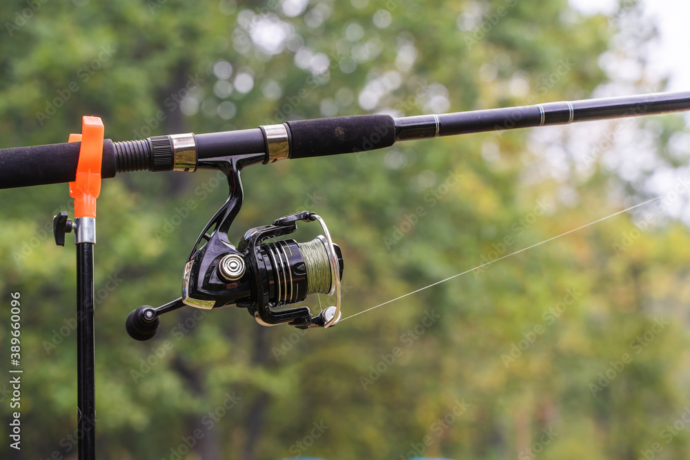 Fishing Rod Spinning with Reel Close Up Photo Fishing Rod Spinning with Reel Close Up Photo