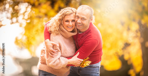 Happy time of a couple in love outside in the colorful fall nature