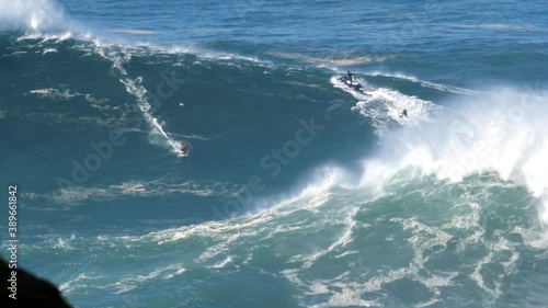 2020 slow motion of a big wave surfer crashing on a monster wave in Nazaré, Portugal. Nazaré is a small village in Portugal with the biggest waves in the world. photo