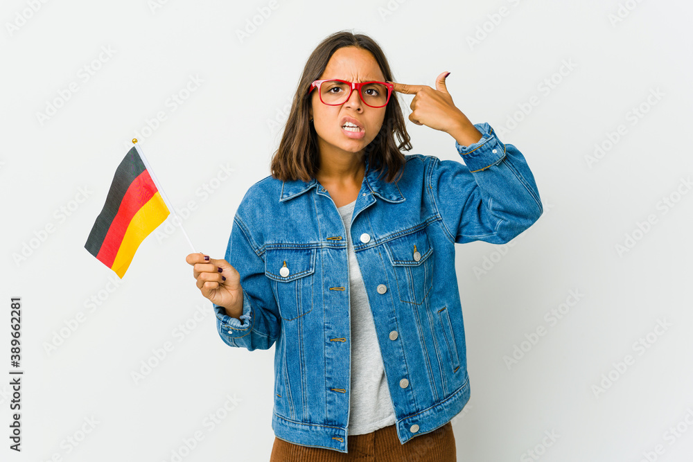 Young latin woman holding a german flag isolated on white background Young latin woman holding a german flag isolated on white background