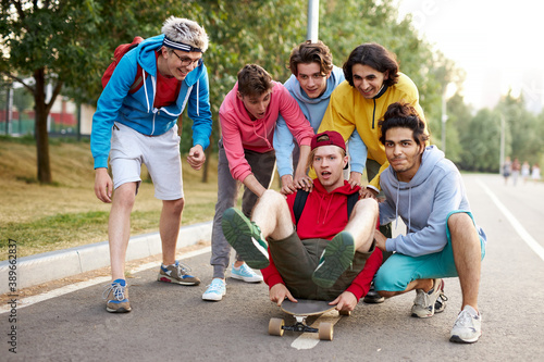 portrait of young sportive team of teenagers with skateboards, caucasina boys engaged in sport, skateboarding, sport concept photo