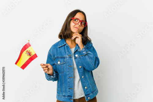 Young spanish woman holding a flag isolated on white background photo