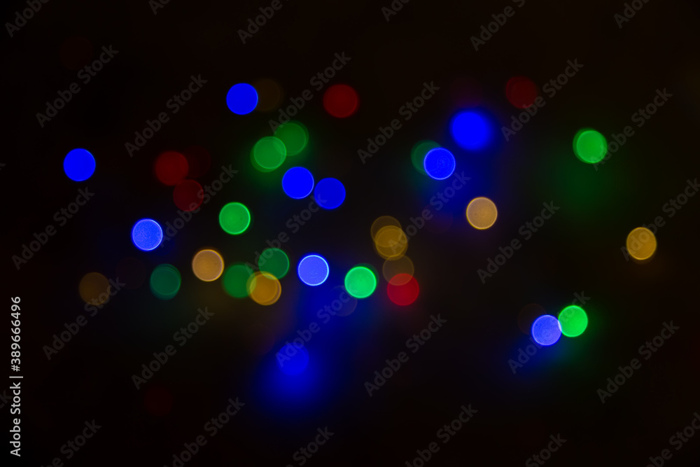 Abstract background, multicolored bokeh on a black background. Abstract background, multicolored bokeh on a black background.