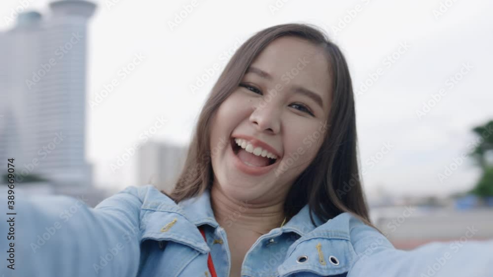 Young Asian woman smile happy to travel during the holidays. Teenage lifestyle Relax during the long weekend. Traveler in a beautiful city park. Travel after lockdown Young Asian woman smile happy to travel during the holidays. Teenage lifestyle Relax during the long weekend. Traveler in a beautiful city park. Travel after lockdown