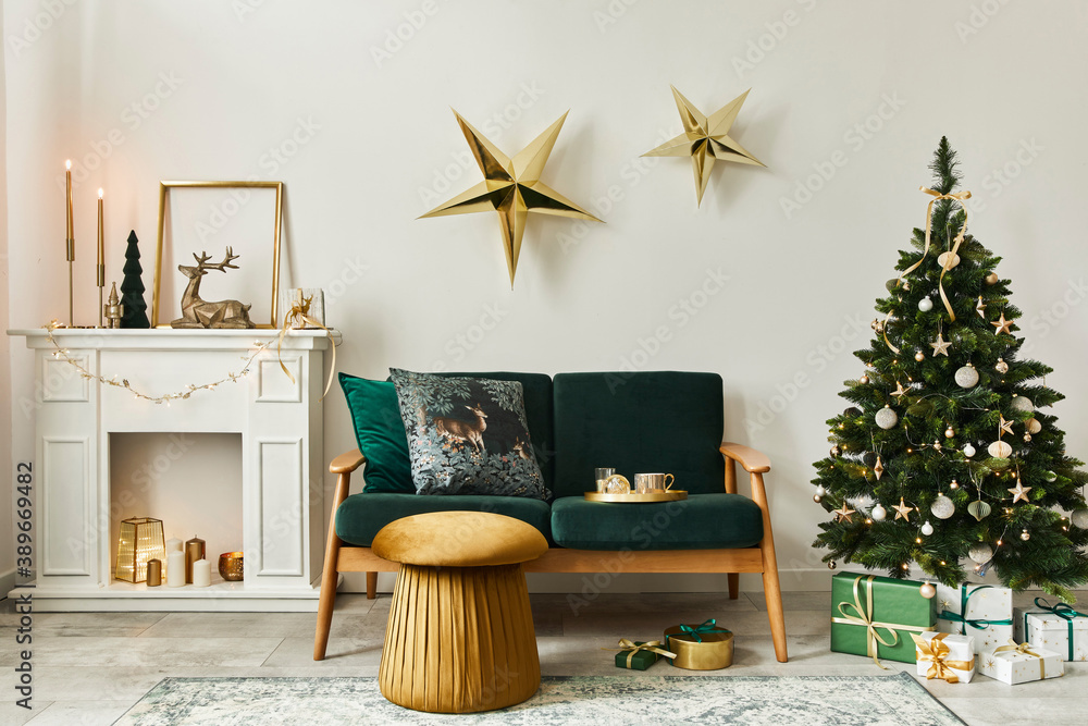 Stylish christmas living room interior with green sofa, white chimney, christmas tree and wreath, stars, gifts and decoration. Family time. Template. - obrazy, fototapety, plakaty 