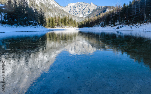 Peaceful mountain view with famous green lake in Austria Styria. Tourist destination lake Gruner See in winter. Travel spot situated in Tragos in lime stone Alps of Hochschwab.