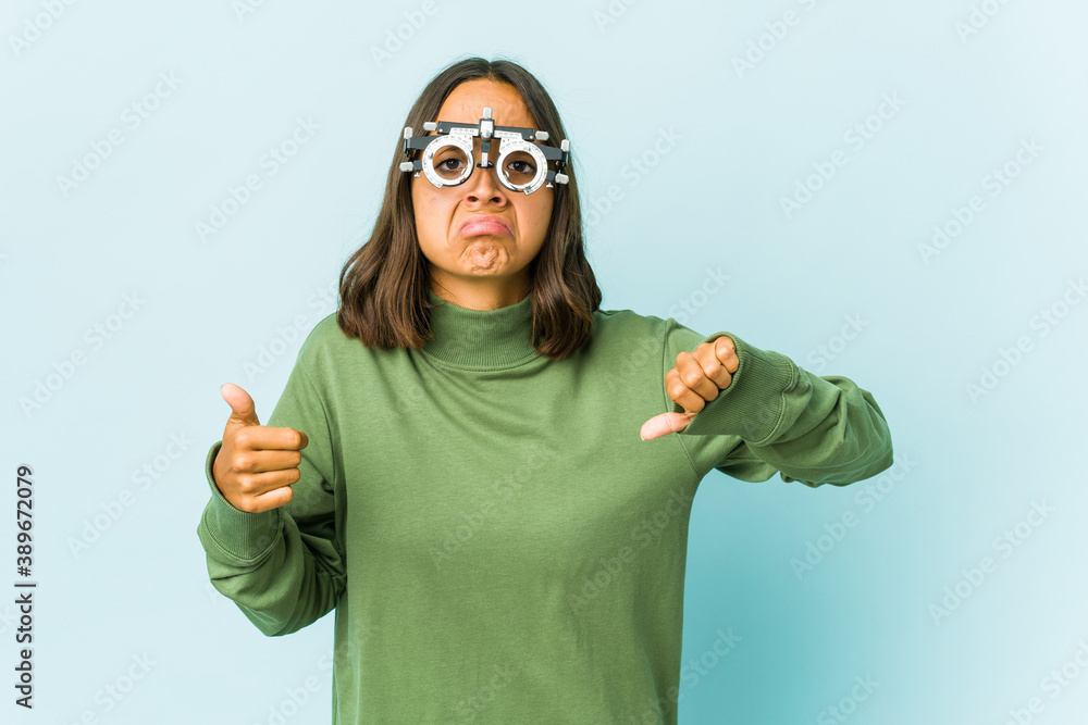 Young oculist latin woman over isolated background Young oculist latin woman over isolated background