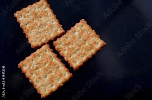 three square cookies on a dark background