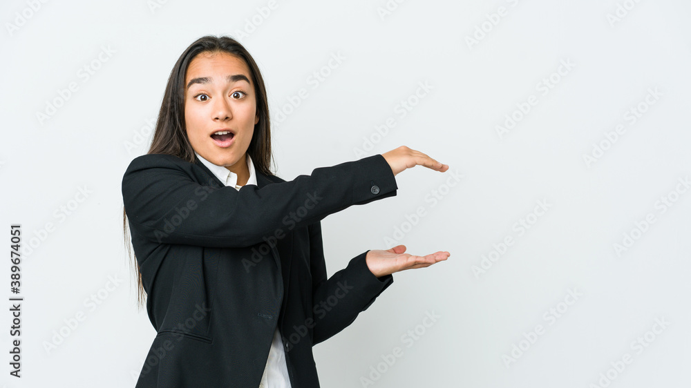 Young asian bussines woman isolated on white background shocked and amazed holding a copy space between hands. Young asian bussines woman isolated on white background shocked and amazed holding a copy space between hands.