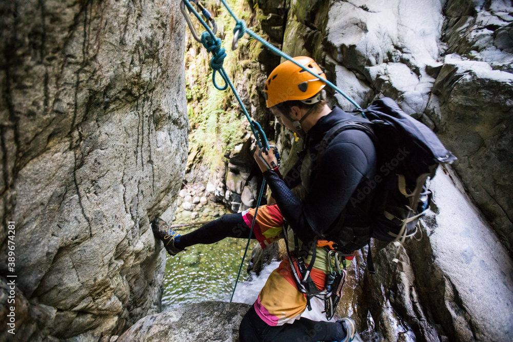 Man prepares to rappel down waterfall near Vancouver, Canada. Man prepares to rappel down waterfall near Vancouver, Canada.