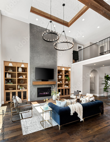 Living room in new luxury home with floor to ceiling fireplace photo