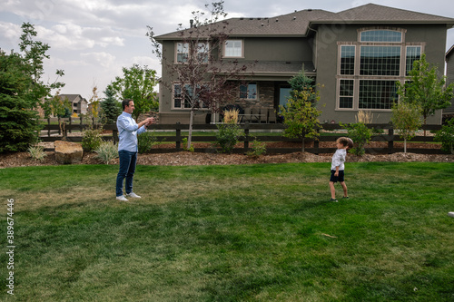 Father and Son playing catch in the backyard photo